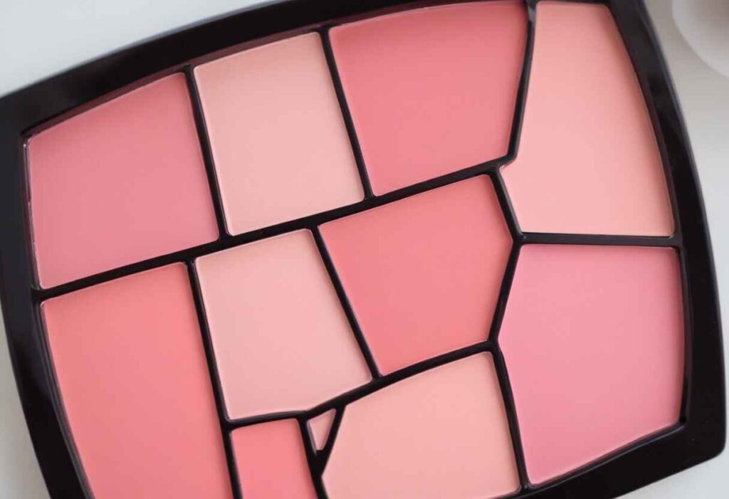 Woman with various blush shades, selecting the perfect blush color